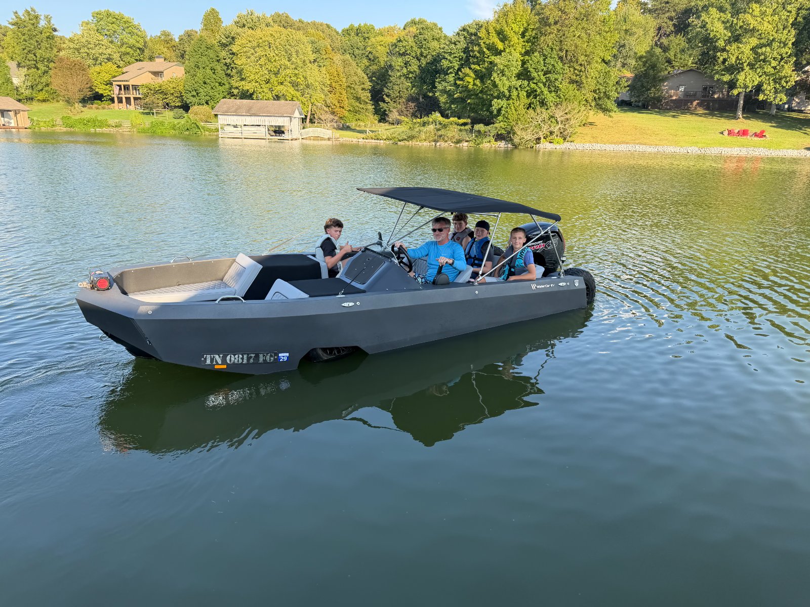 Jordan at the helm with a boatload of neighborhood kids on the lake