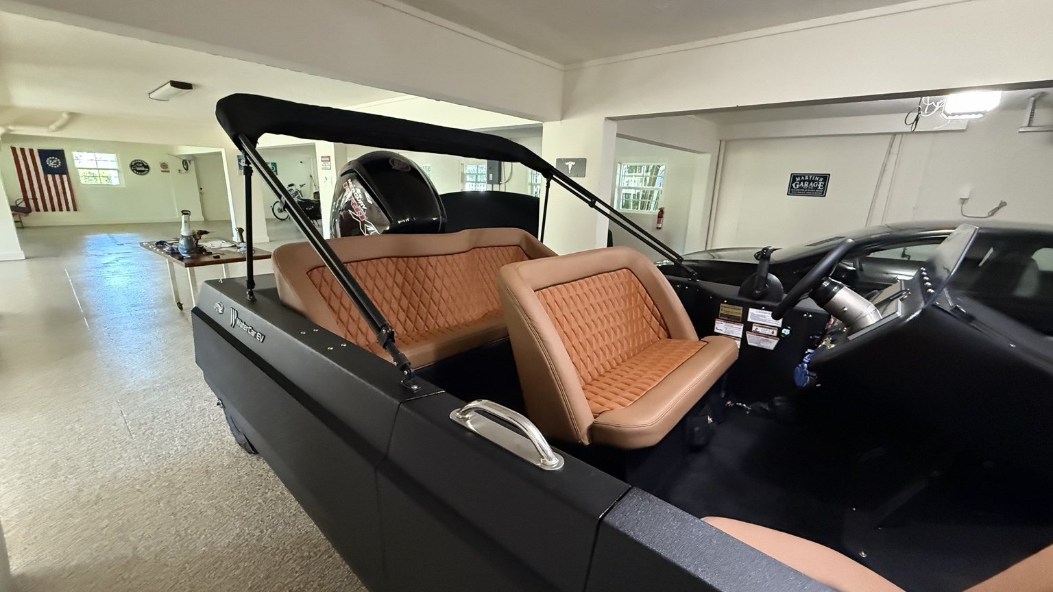 Diamond-stitched tan leather benches in Martin’s black WaterCar EV