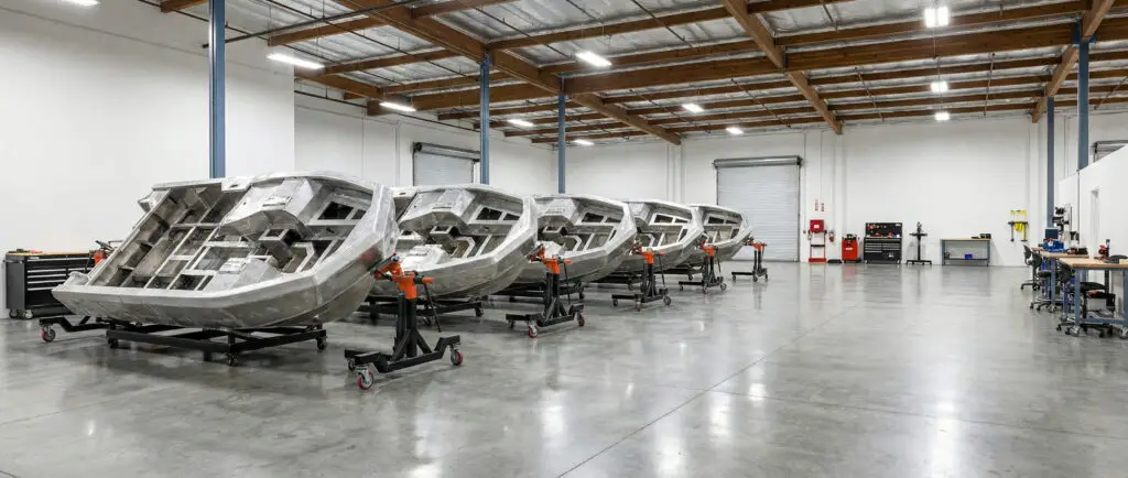 Aluminum WaterCar hulls lined up in the workshop during construction.