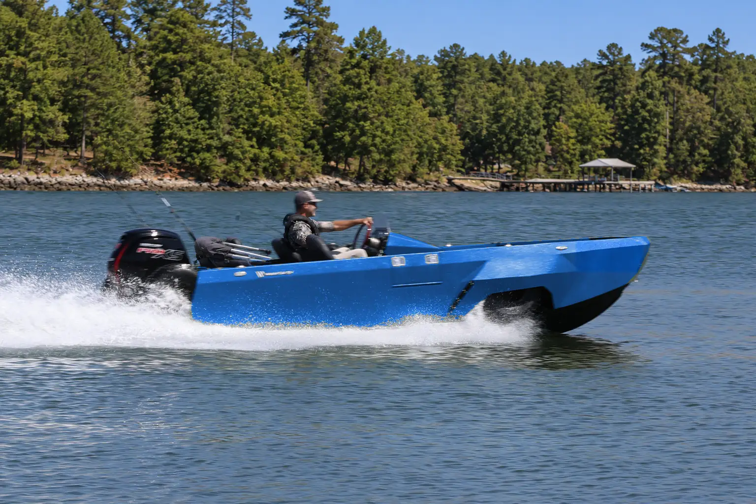Cobalt WaterCar Adventure underway on a wooded lake.