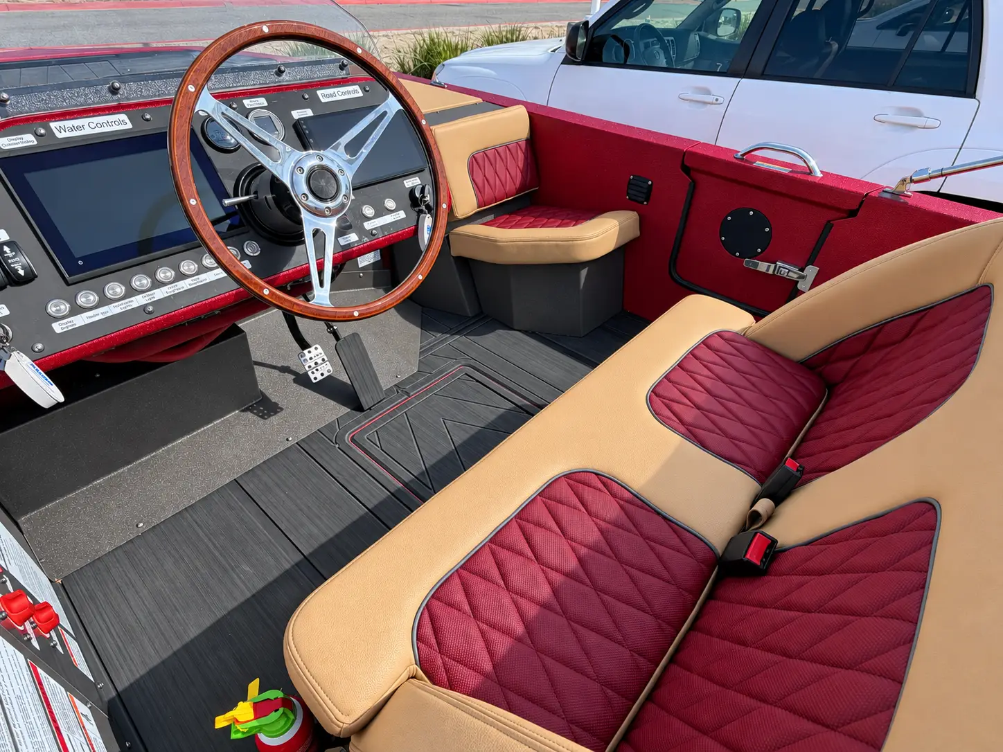 Burgundy and tan diamond-stitched Signature upholstery with the steering wheel and twin touchscreens.