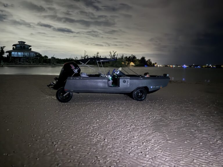 Side view of Jordan's WaterCar parked on the beach at night