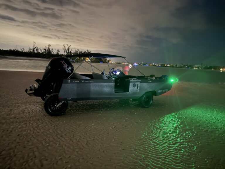 Jordan's WaterCar on the beach at night with its green navigation light illuminated