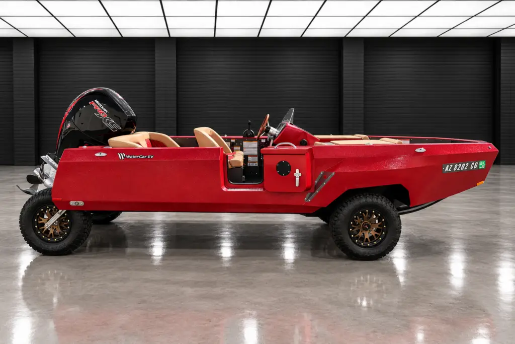 Metallic red WaterCar Signature in full side profile, parked with its outboard and road wheels visible.