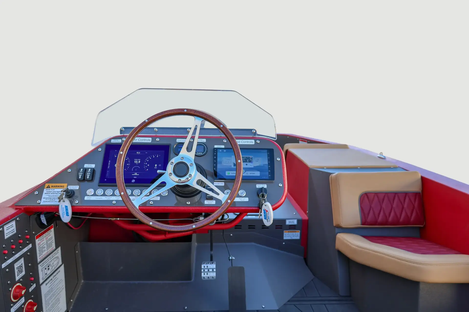 Red WaterCar cockpit with a wood-rim steering wheel, two displays, labeled controls and tan and burgundy seating.