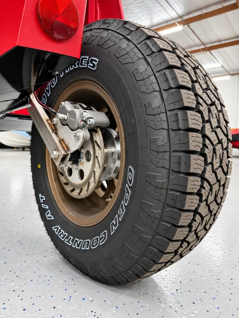 Close-up of the disc brake, wheel and suspension arm on a red WaterCar.