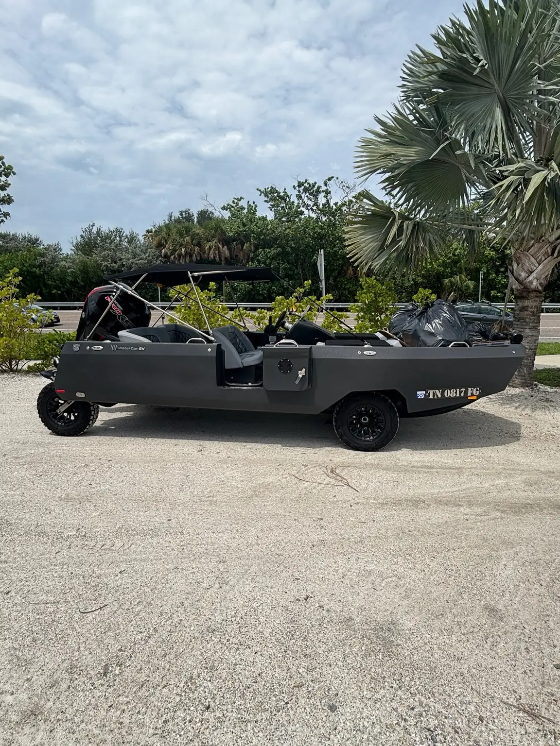 Jordan’s black WaterCar with Tennessee registration parked beside a palm tree