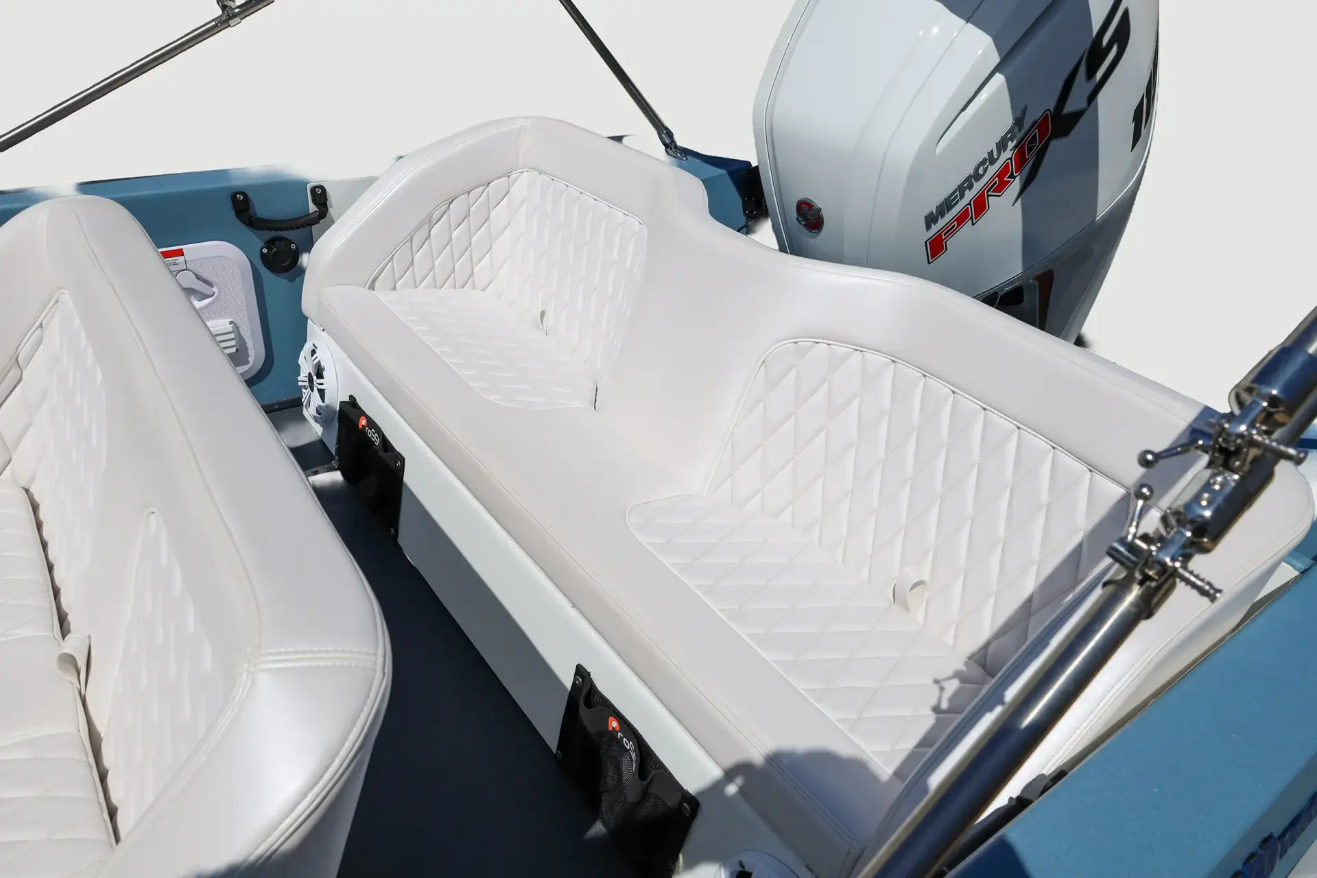 White quilted seating in a pale blue WaterCar, with canopy supports and a Mercury Pro XS outboard.