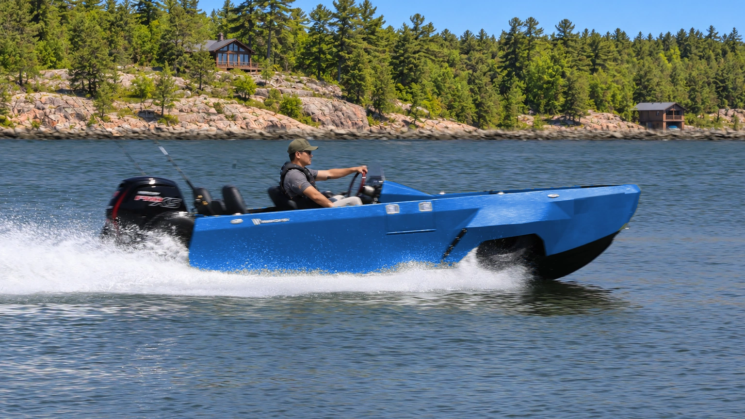 Cobalt WaterCar Adventure underway on a wooded lake.