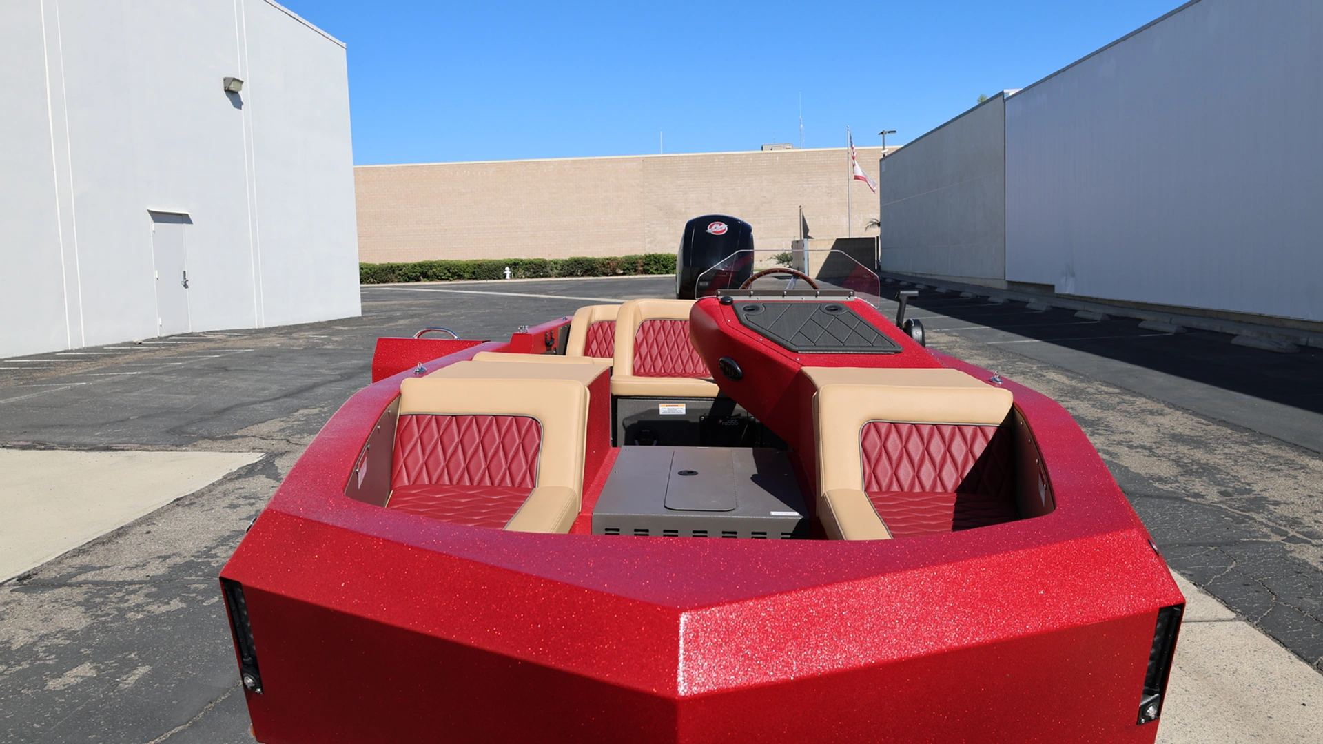 Red and tan upholstered bow seating in a WaterCar Signature, photographed at the factory.